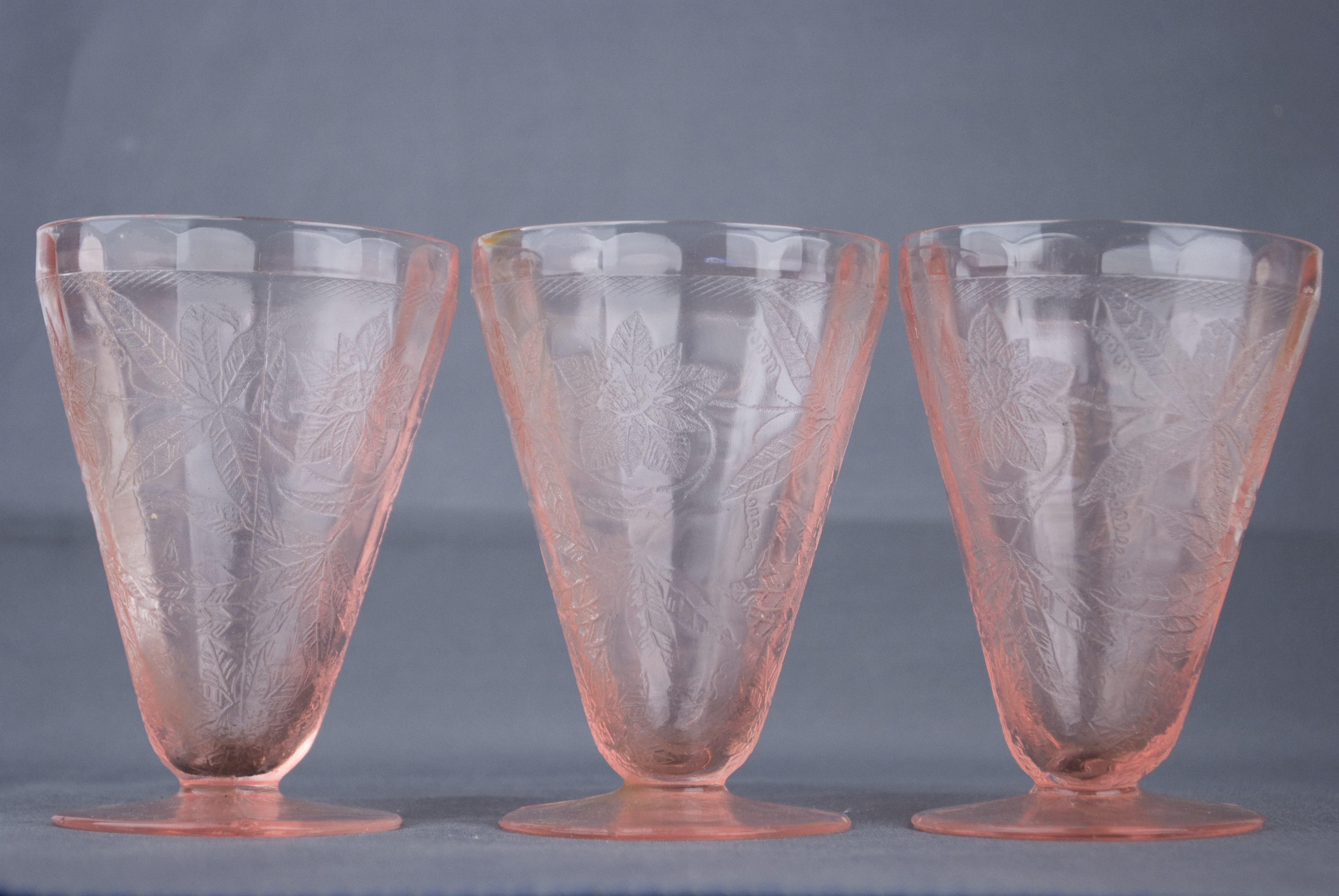 Three pink depression glass cups